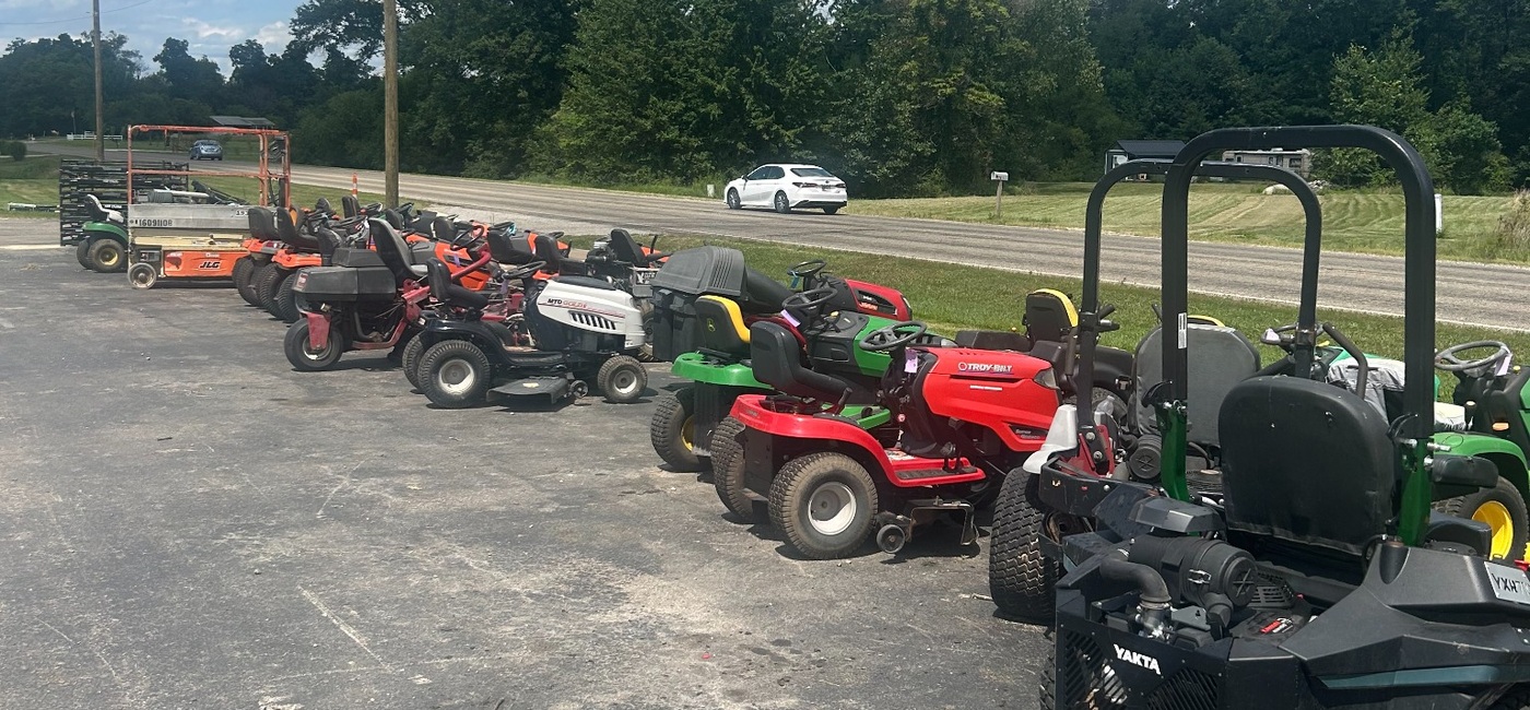 Row of used equipment on the lot at M&M Mower Repair